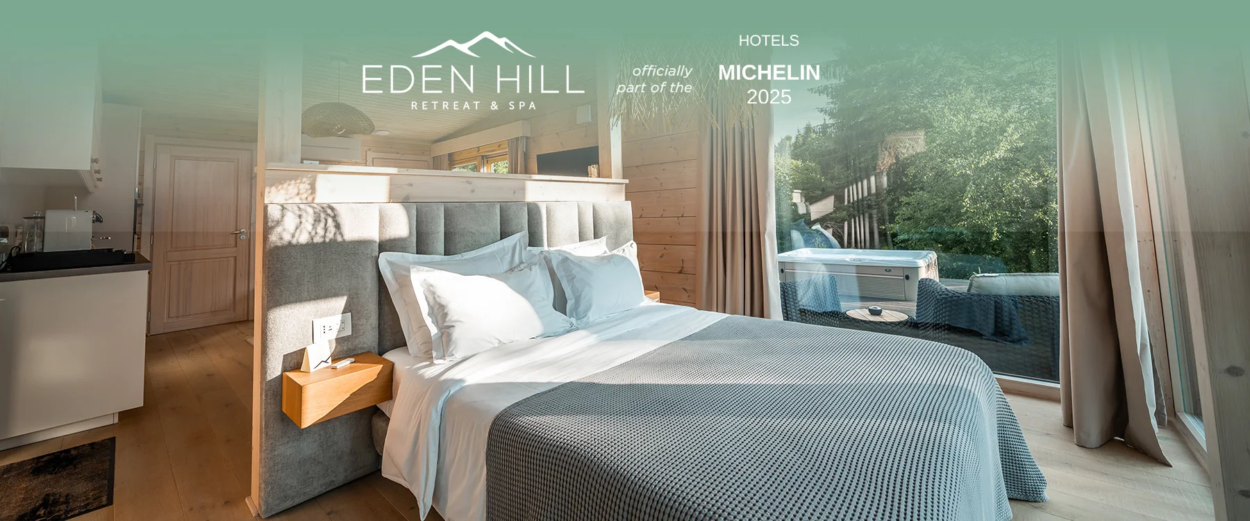 Wood-lined Eden Hill bedroom overlooking a hot tub, in a composition with the Michelin Hotels 2025 badge.