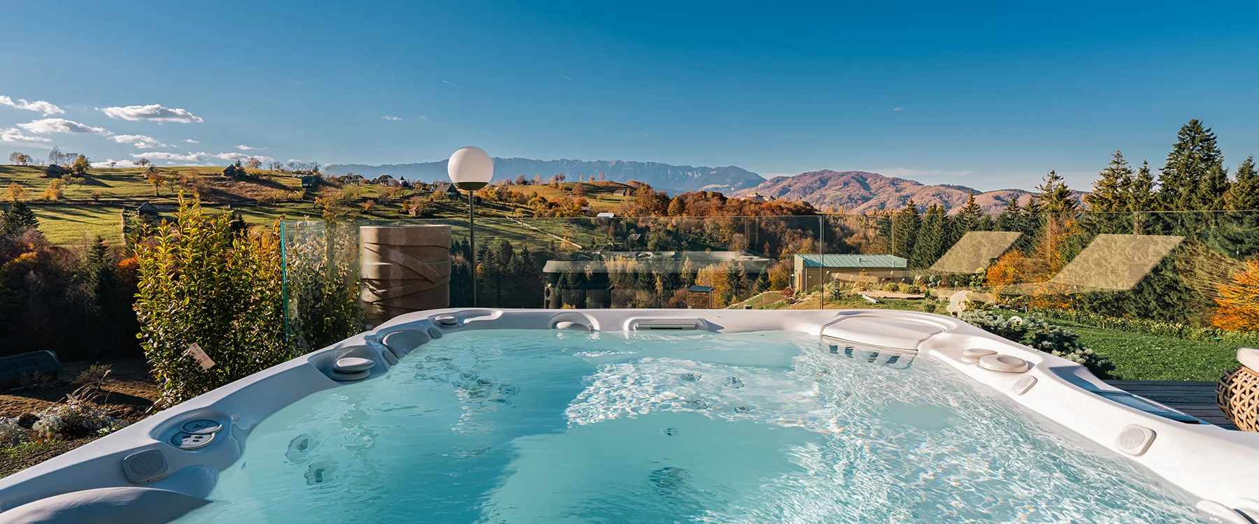 Hot tub with a panoramic view of hills and mountains from an Eden Hill terrace.