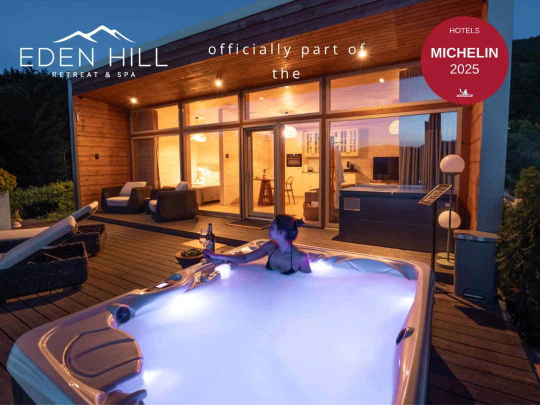 Illuminated hot tub outside an Eden Hill villa at night, with the Michelin Hotels 2025 badge overlaid.